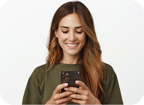 Person looking at a phone while holding a smoothie.